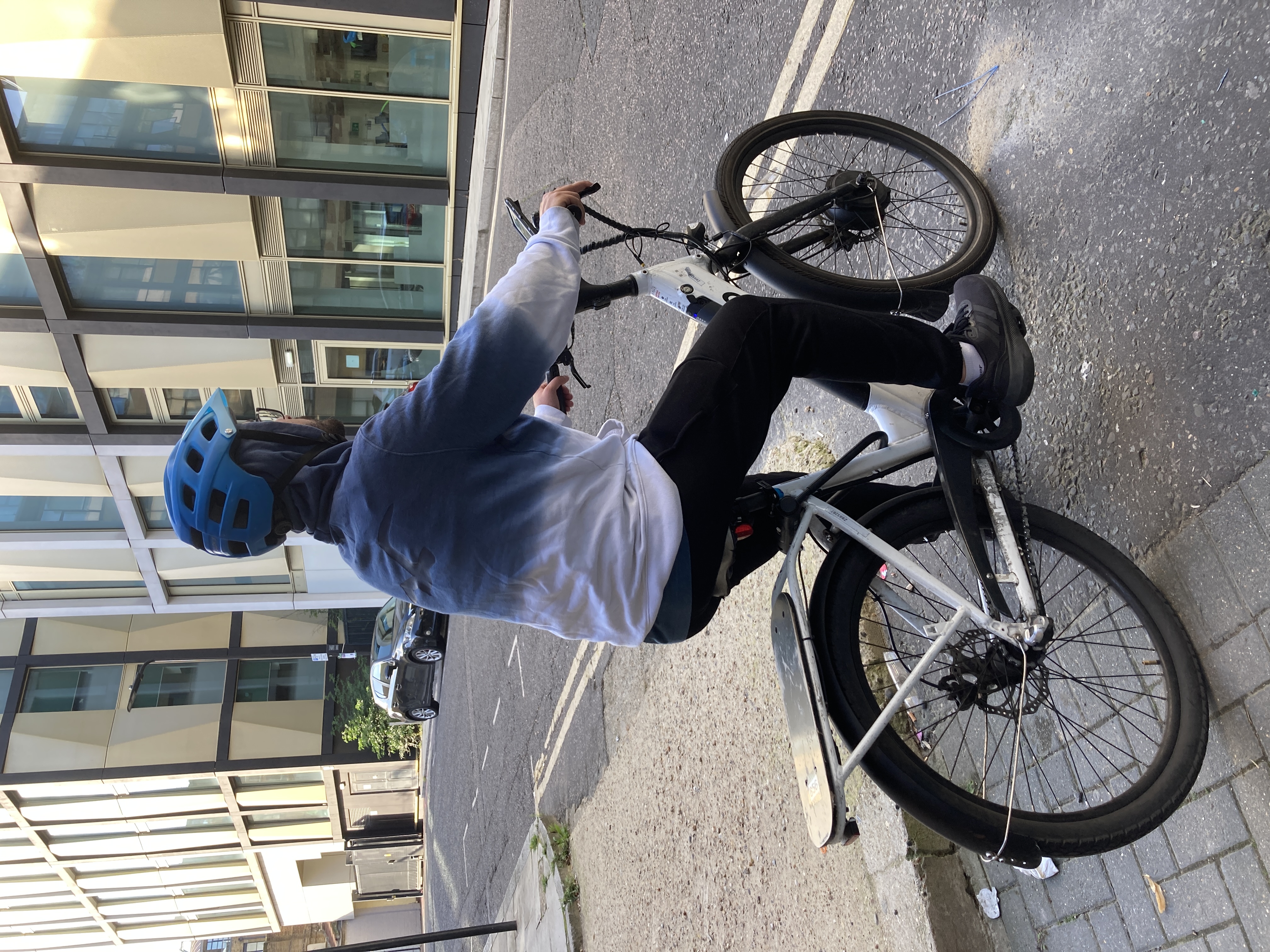 Delivery cyclist on his bike, at a junction.